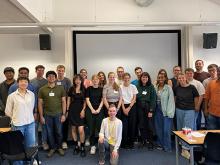 Large group of people smiling as they pose for a picture